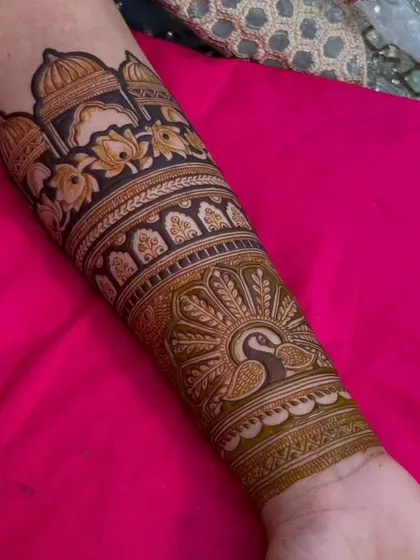 A full view of the arm piece from the previous images, showing how the palace and peacock motifs come together in a cohesive design.