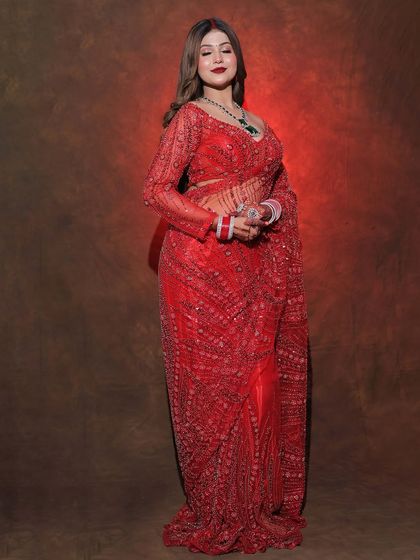 A full-length shot of the red sequined saree, showing its glamorous look.