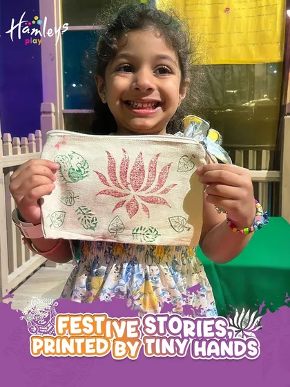 A happy girl shows off the pouch she decorated with block prints during our festive workshop. She chose the colors and stamps herself to create a one-of-a-kind piece of art.