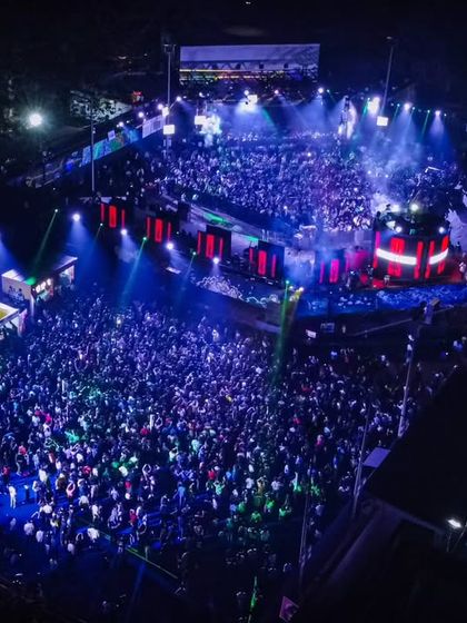 An aerial drone shot of the massive crowd at the Techfest EDM concert. The scale of these events is breathtaking.