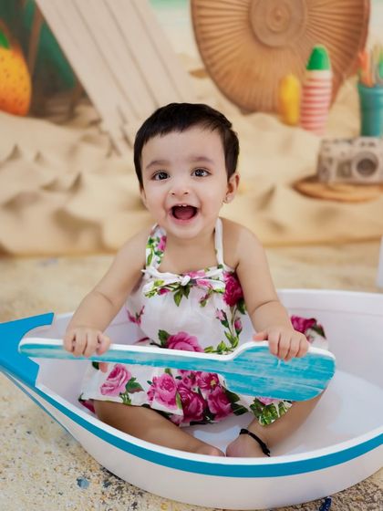 All aboard for fun! This baby is having a great time in her little boat as part of our beach-themed photoshoot.