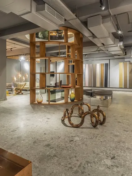 The expansive showroom at SIRCA HQ, designed as an experience center. The industrial aesthetic with polished concrete floors and track lighting allows the product displays to take center stage.