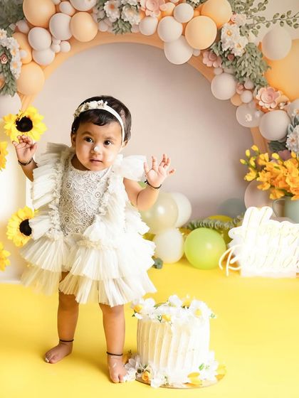 Standing tall and proud for her first birthday! This sunflower themed setup is one of my favorites for creating bright, happy, and memorable first birthday portraits.