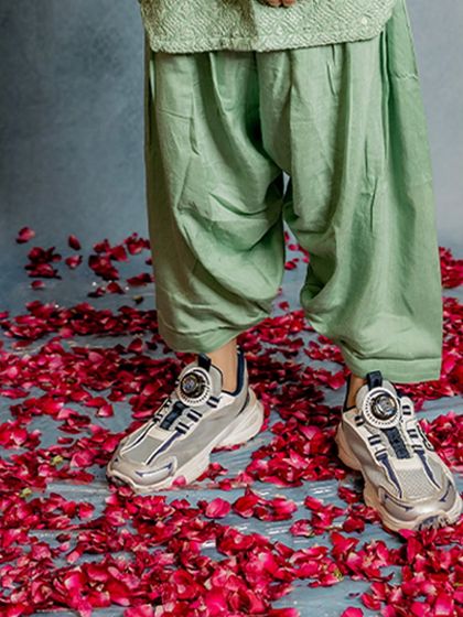 A fun detail shot showing our mint green Patiala pants paired with cool sneakers. It’s a modern way to style traditional wear, perfect for today's kids.