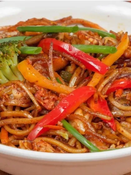 A satisfying bowl of our loaded Stir-Fry Noodles. We toss noodles with a generous amount of chicken, crisp bell peppers, broccoli, and onions in a savoury sauce for a complete meal.