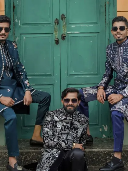 A group of men showcasing a variety of my heavily embroidered indowestern jackets in shades of blue, black, and white.