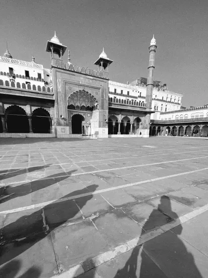 The shadows of our tour group stretch across the courtyard of the majestic Jama Masjid. This black and white shot captures a quiet moment of reflection during our walk.