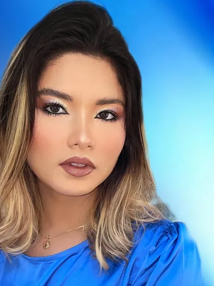 The final look from the transformation, showcasing a radiant complexion and beautifully blended eye makeup.