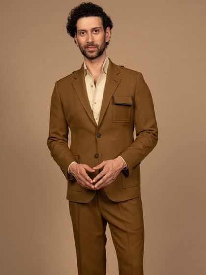 A full view of the mustard suit, showcasing its all-weather fabric and contemporary design. It’s a suit built for the modern professional on the move.