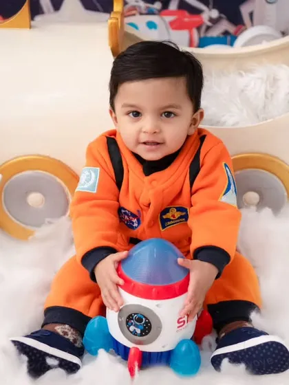 A little astronaut ready for his mission. The detailed costume and space-themed props make this a truly out-of-this-world photoshoot.