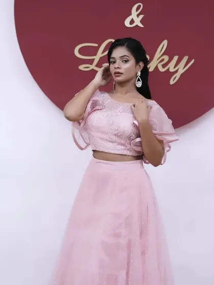 A full-length shot against a branded background, perfect for an event or a brand activation. The look is polished and professional.