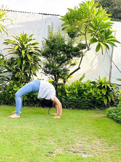 A full Urdhva Dhanurasana (Wheel Pose) in the garden. Backbending outdoors, under the open sky, is a truly liberating experience.
