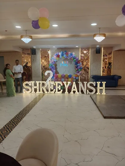A wide shot of a second birthday setup. The large, illuminated name and number take center stage, showing how we can make a grand statement even in a simple setup.