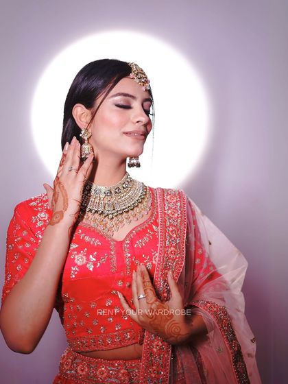 A soft, elegant pose in our pink lehenga. This look is perfect for showcasing romantic and classic bridal makeup styles.