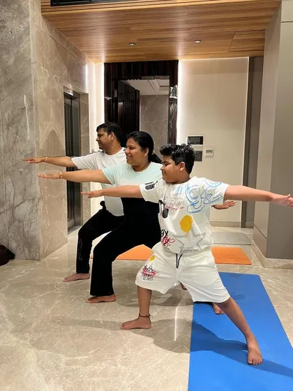 A family yoga session at their home in Delhi. I offer personal training for individuals and small groups, making it convenient to practice together. Here, we are working on the Virabhadrasana II (Warrior II) pose to build strength and stamina.