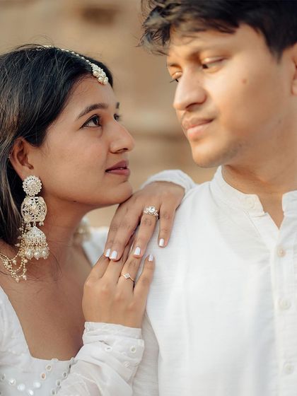 A close-up portrait highlighting the tender connection and intricate details, from the bride-to-be's jewelry to the gentle look in their eyes.
