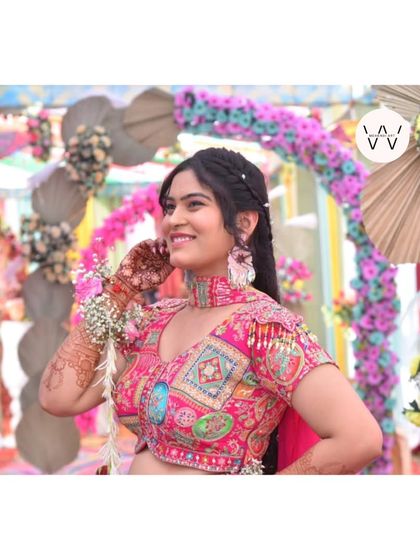 A smiling client showing off her lovely henna stain.