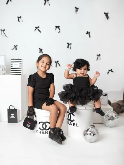 A little bit of fashion and a whole lot of fun for these two sisters. This creative Chanel-themed studio shoot shows how we can play with concepts to create unique and memorable portraits for your children.