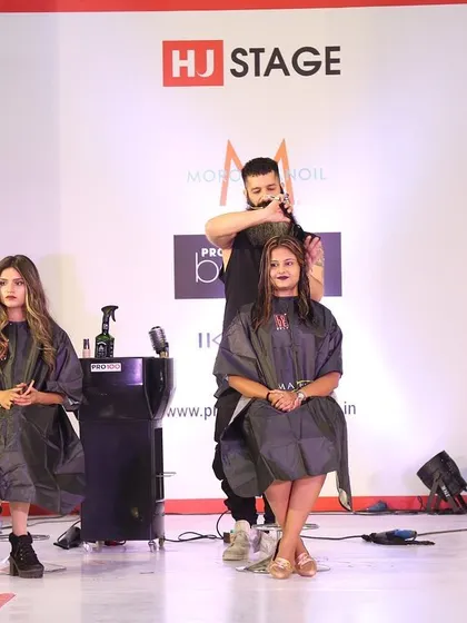 A shot of me and my fellow stylists working on our models during the "Funky Summer Cut and Color" live demo. The energy at these events is always incredible.