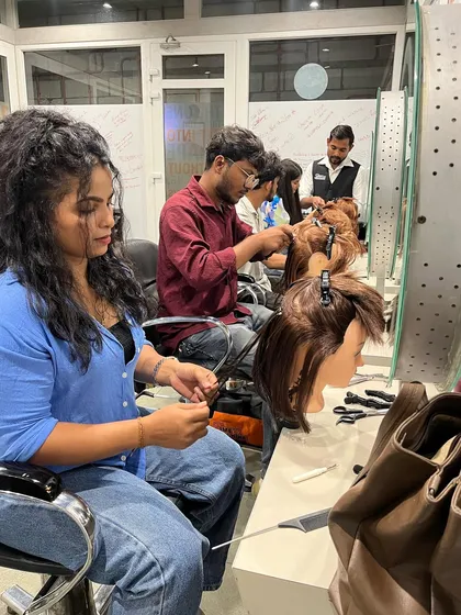 A busy classroom during our hair extensions training, with every student focused on mastering the technique.