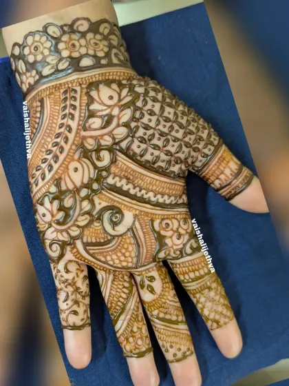 A beautiful Indian mehndi design combining fish motifs with floral and geometric patterns.