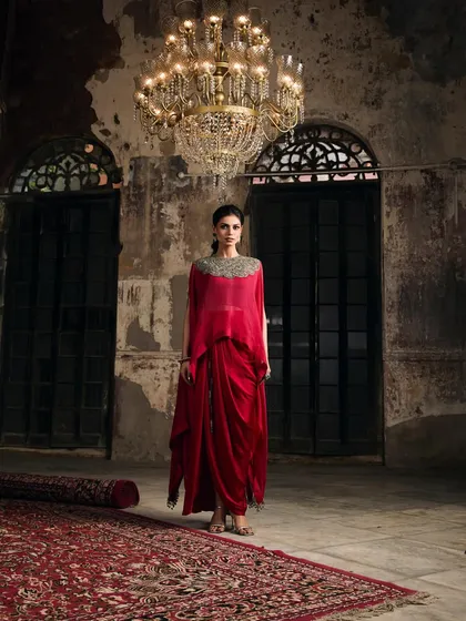 This is where modern drama meets timeless elegance. I love helping clients find showstopping pieces like this draped red gown with an embellished neckline, perfect for making an unforgettable entrance at a wedding reception or gala.