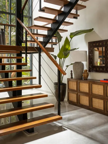 We replaced a solid staircase with this light, open-riser design to improve the flow of light and space. The wood treads and sleek metal supports create a modern architectural feature.