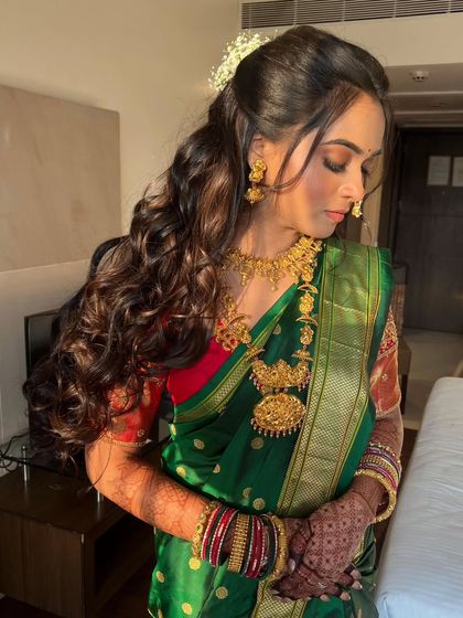 Long, voluminous curls for a Maharashtrian bride. This half updo style is perfect for showing off long hair while still looking traditional and elegant.