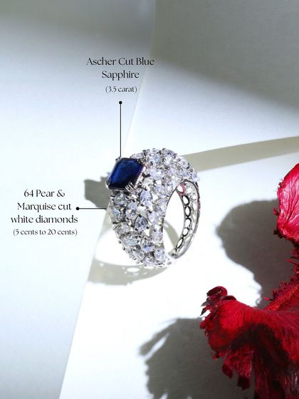 A detailed view of another stunning Blue Sapphire Cocktail Ring, this one featuring a 3.5-carat Ascher-cut sapphire set amidst 64 pear and marquise-cut white diamonds.