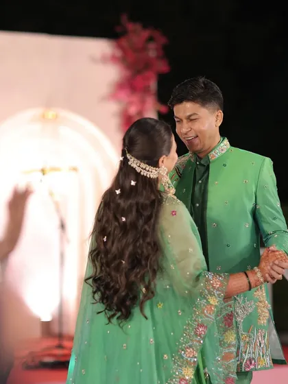 A beautiful candid moment of the couple dancing at their Qawwali night. The bride's whimsical hairstyle with butterfly clips looks magical as she moves.