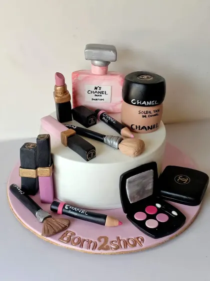 A wider shot of the "Born 2 Shop" makeup cake, showing the full collection of edible cosmetics.