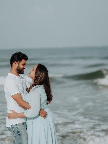 A quiet moment of connection with the ocean waves in the background, perfect for a serene and romantic couple portrait.