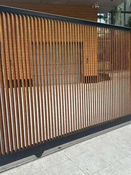 Your main gate is the first impression of your home. This custom sliding gate uses our durable, low-maintenance Tipwood in a vertical slat design, blending security with modern aesthetics.