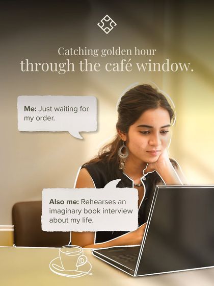 Main character energy. A customer working on her laptop, catching the golden hour light through the cafe window.