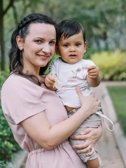 A mother and son portrait, her expression full of love as she holds him close.