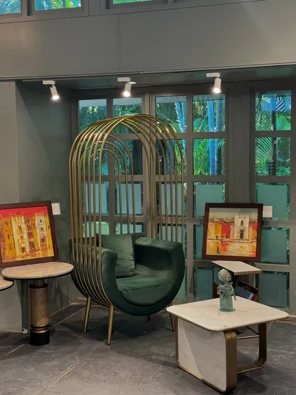 Our iconic "birdcage" canopy chair in green velvet, creating a stunning focal point at our design exhibition.