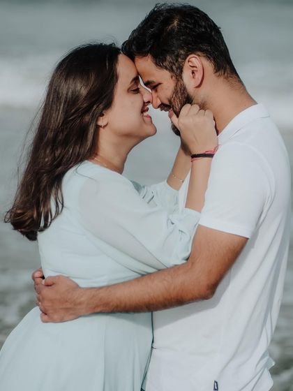 A playful and affectionate moment, capturing the fun and loving nature of the couple's relationship by the sea.