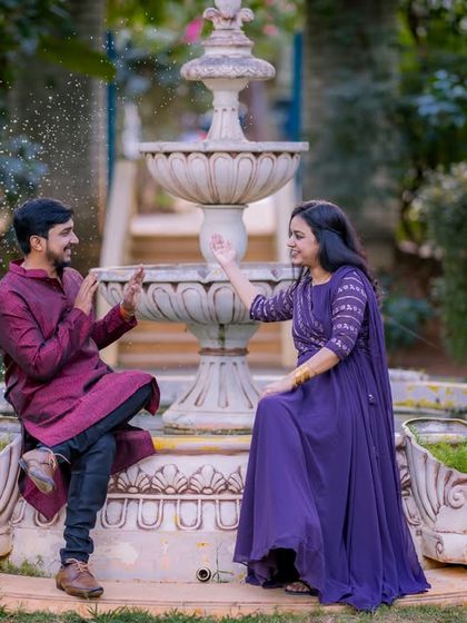 A playful moment by our classic white tiered fountain, a centerpiece in our garden that adds a touch of European elegance.