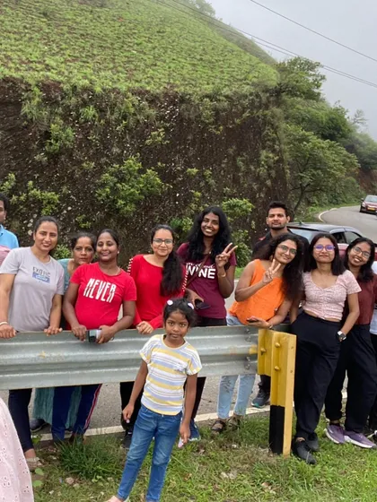 A group of women travelers on a misty road in Chikmagalur.