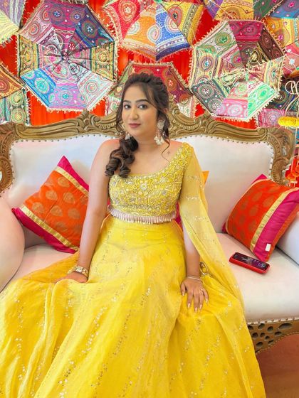 Another shot of the bride on the Haldi stage, looking confident and happy. The makeup is designed to look great in photos and last throughout the event.