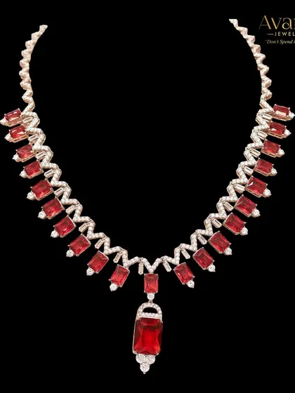 A close-up of the fiery red zircon statement necklace. This piece is for the bold and confident woman who loves to stand out from the crowd with her jewellery choices.