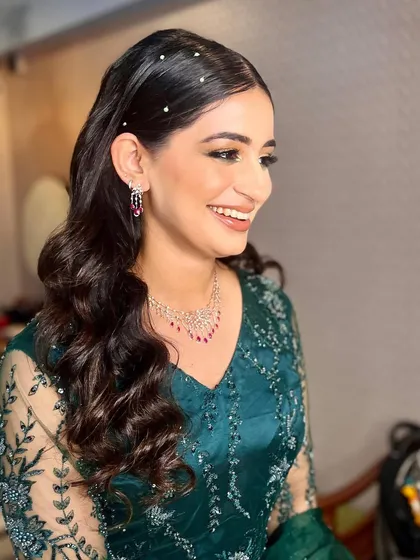 A smiling bride-to-be with her soft, pearly waves. This hairstyle is sophisticated and modern, perfect for a bride who wants a chic and polished look for her pre-wedding festivities.