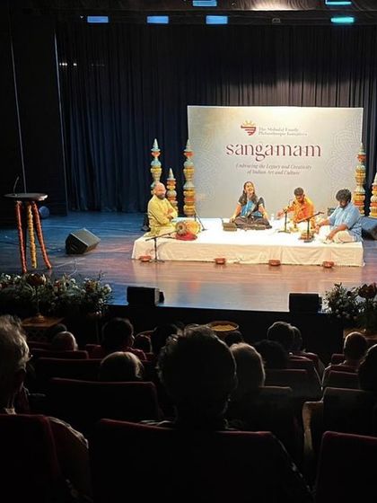 Another shot from the back of the hall at the Sangamam concert, showing the full stage and audience.