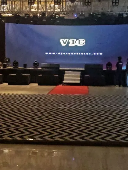The calm before the storm. This is the setup for a large gala, with the dance floor ready and my logo on the big screen, waiting for the party to begin. A professional setup is key to a great event.