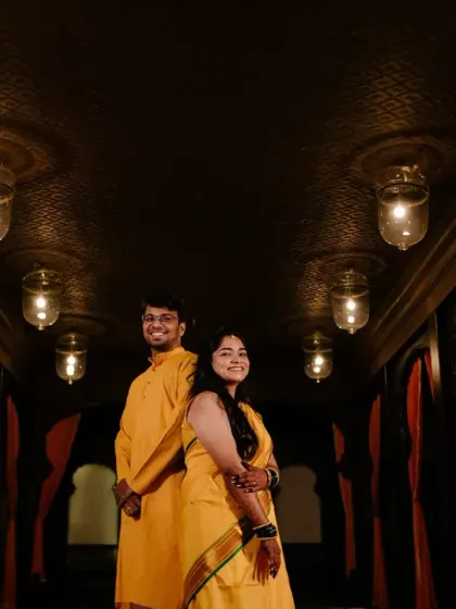 A creative portrait of the couple in a dramatically lit hallway, their matching yellow outfits creating a striking visual.