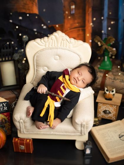 Even the most powerful wizards need their nap time. This shot captures the peaceful side of our Harry Potter theme, focusing on the baby's serene expression.