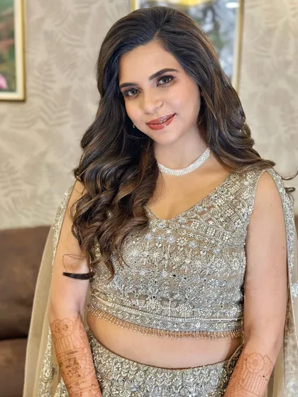The bride's happy and confident smile shows how beautiful she feels. This look is perfect for a modern evening event.