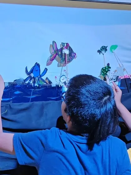 Children creating a magical underwater world with shadow puppets they made themselves during our summer workshop.