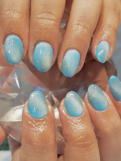 A truly "eye-catching" nail art design. This is a beautiful example of a sky blue cat-eye effect, creating a soft, shimmering look reminiscent of a clear sky.