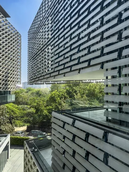 At the Mankind HQ in New Delhi, cantilevers and layered terraces project the workspace outwards. This design frames views of the adjacent park and draws daylight deep into the building.